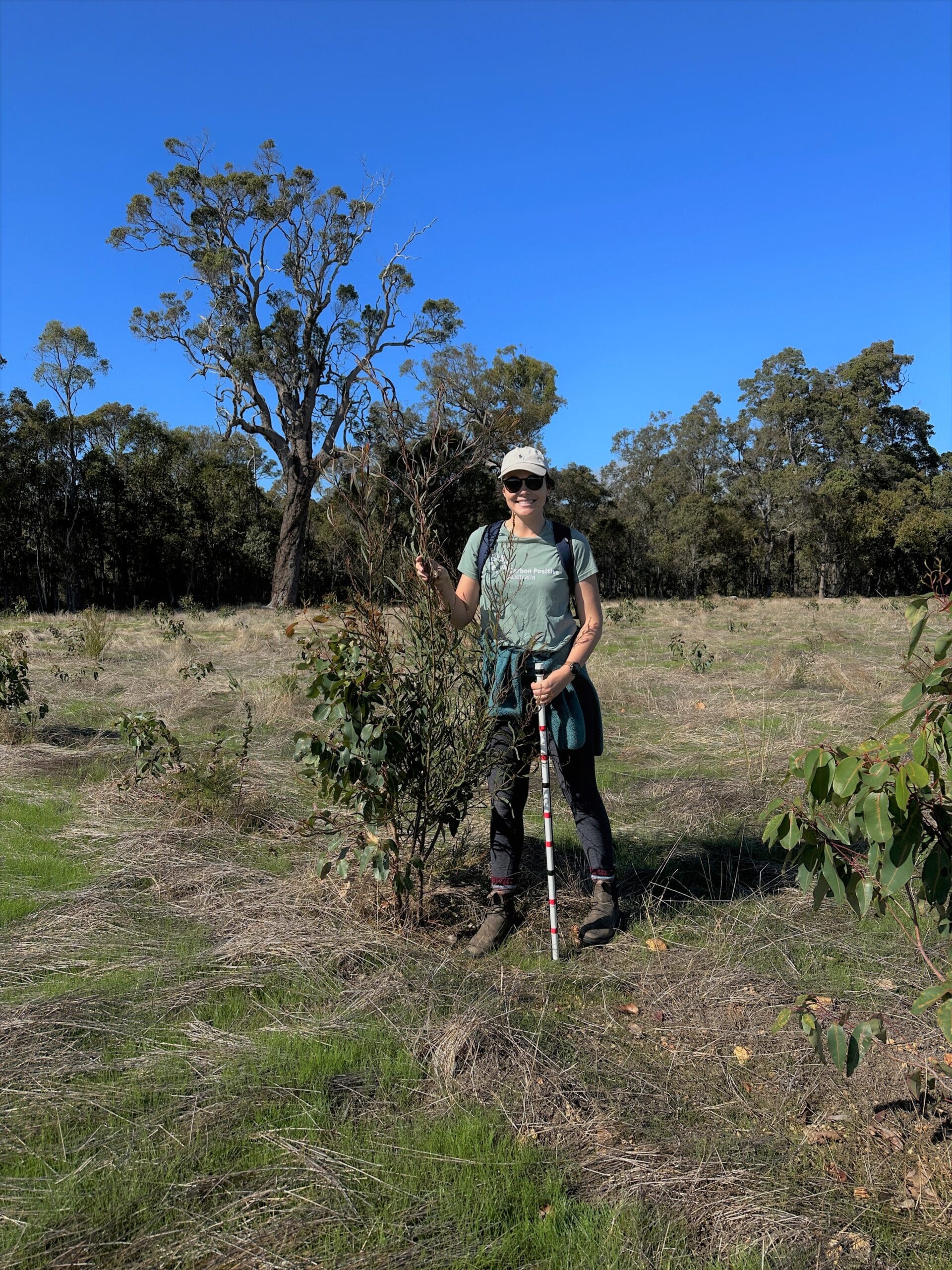 Woman standing next to tree