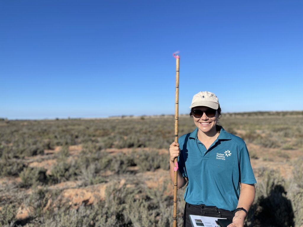 Carbon Positive Team member on site monitoring planting