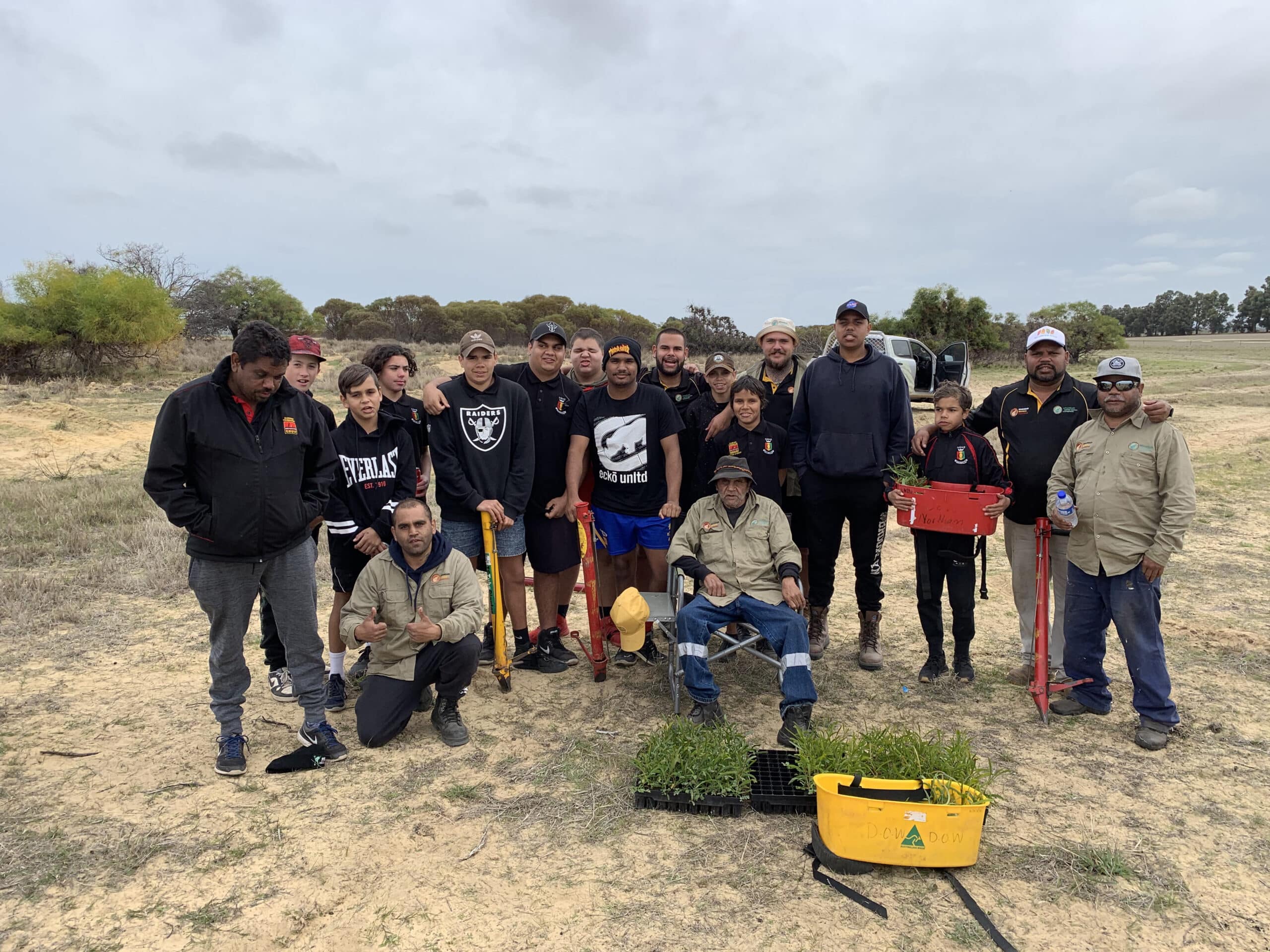 Group photo with planting equipment