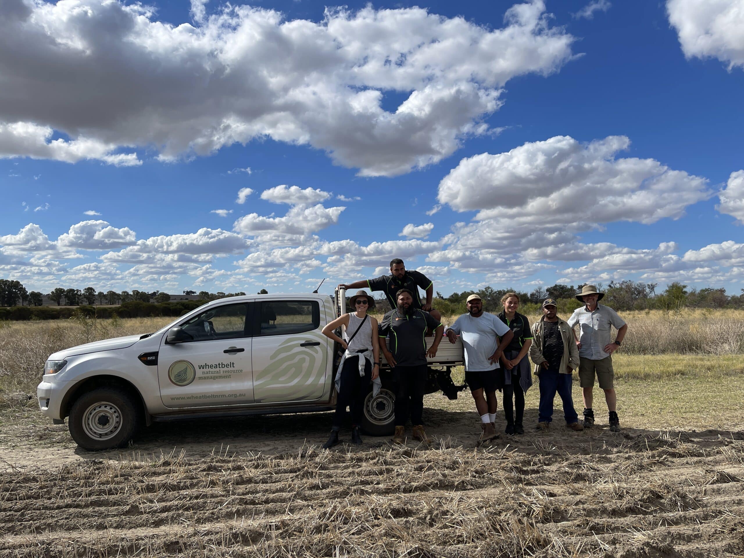Group photo of planting team next to a ute.