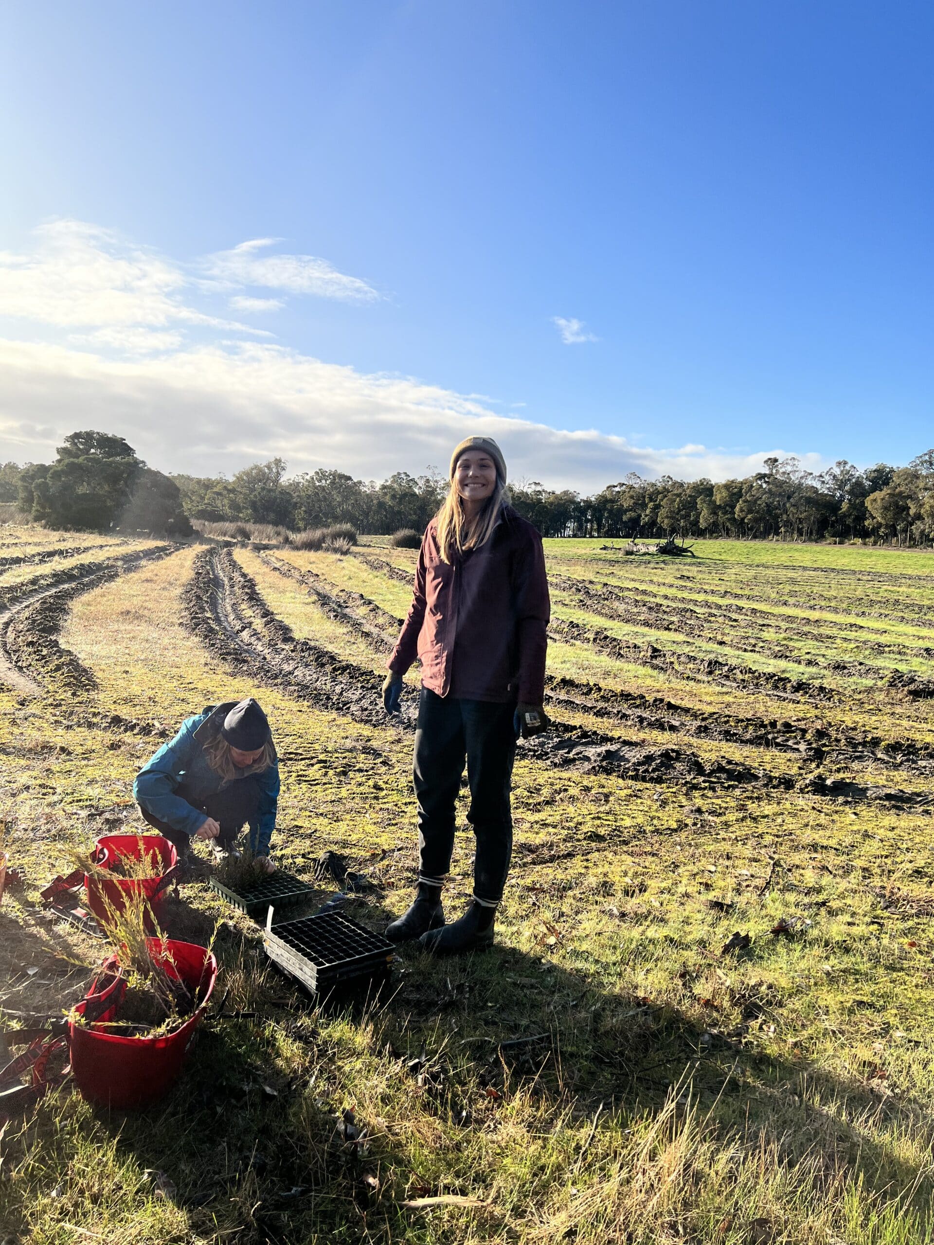Two women packing seedling buckets
