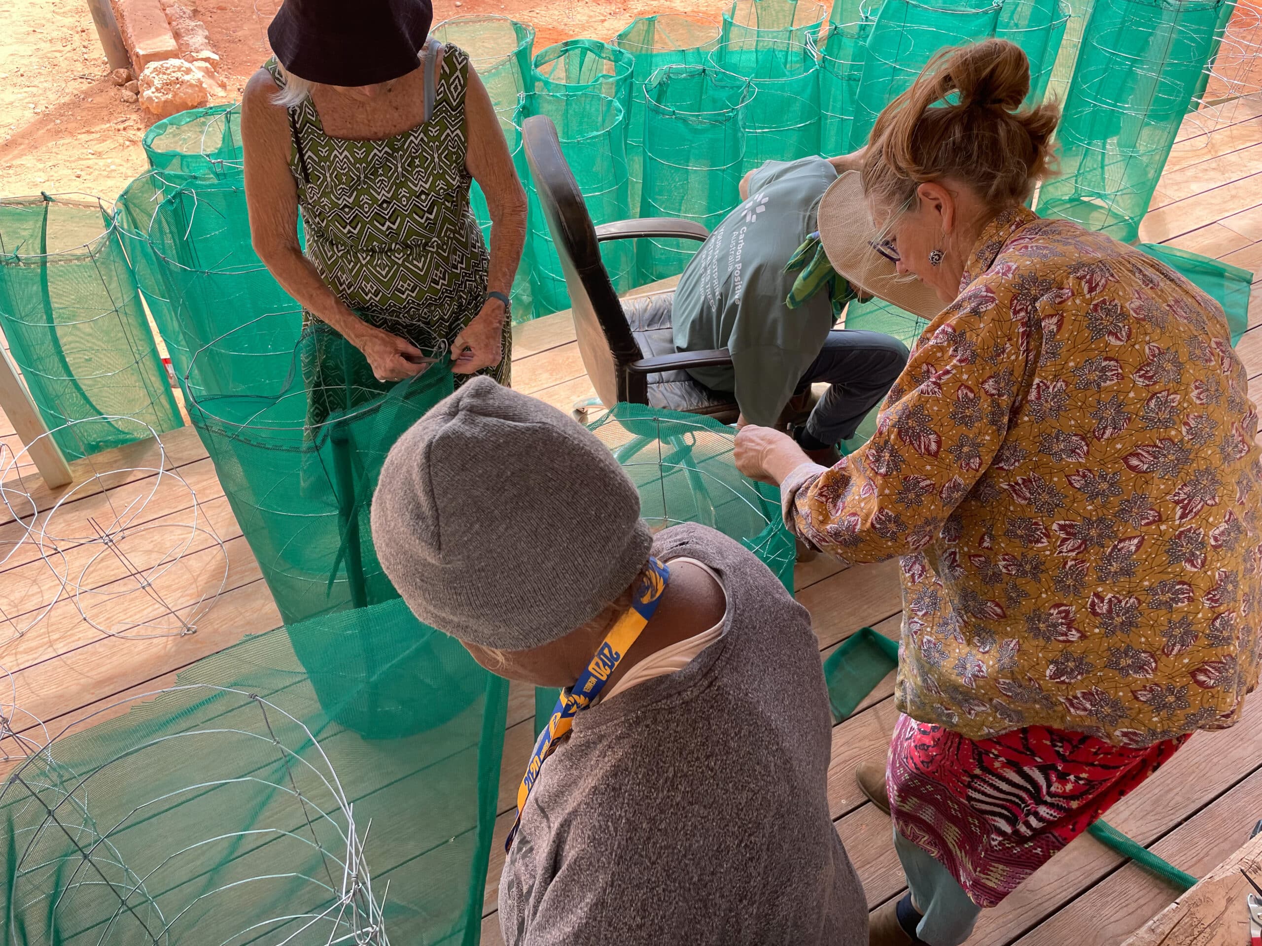 CPOZ volunteers and Tjuntjuntjara community members making tree guards.